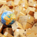 A globe among a pile of shipping boxes, representing international parcel services.